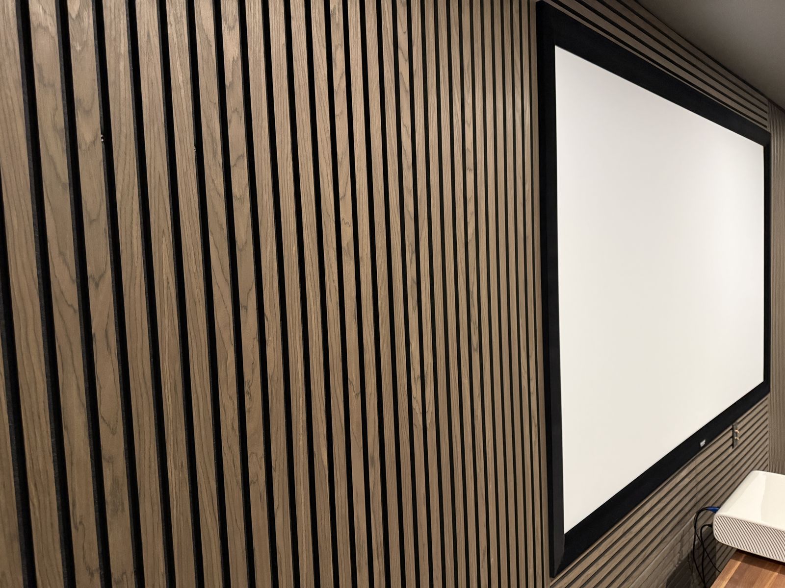 Slat Studio walnut acoustic feature wall in a Kelowna home theatre