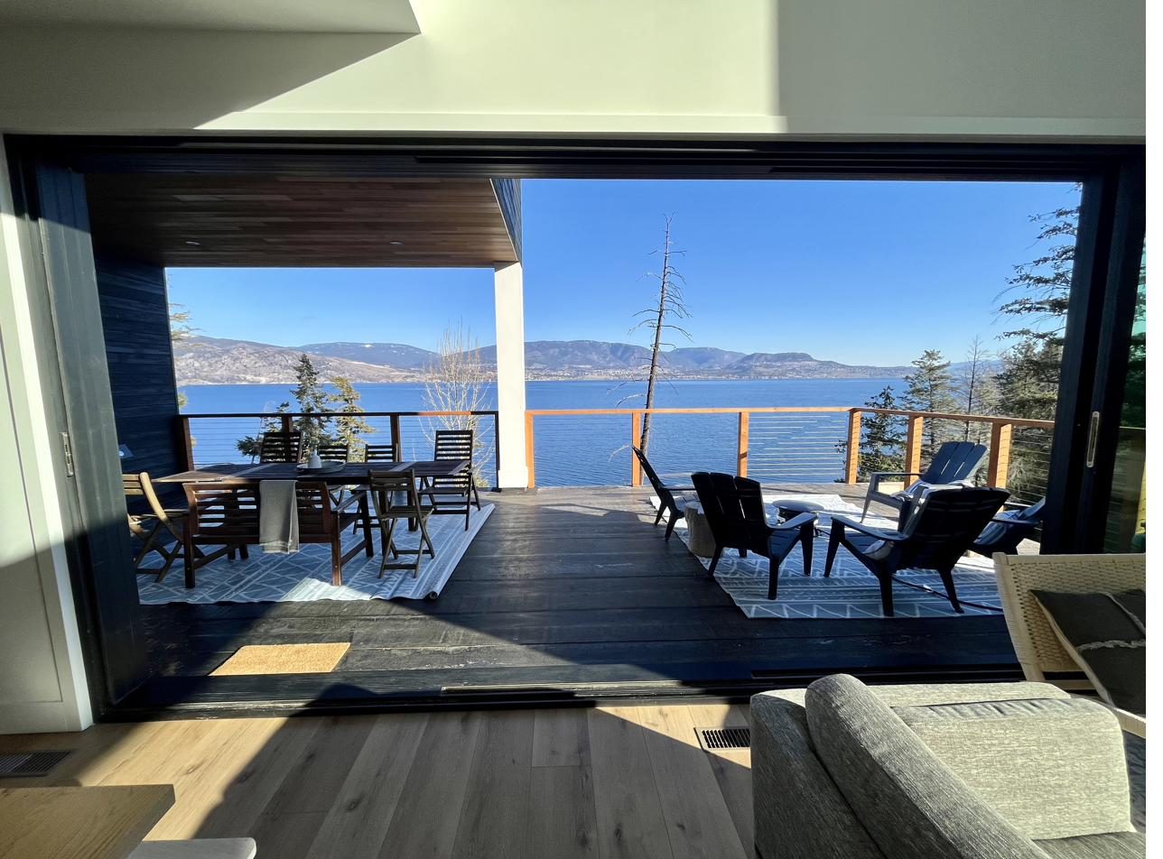 Covered outdoor living area with a lake view